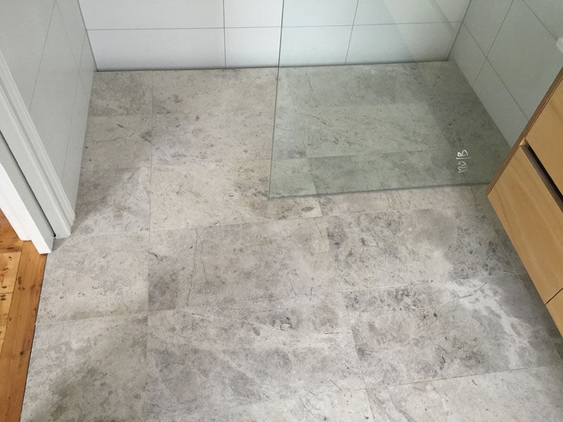Elegantly polished marble-tiled shower area by Waterside, Penrith&rsquo;s renowned tiling specialists